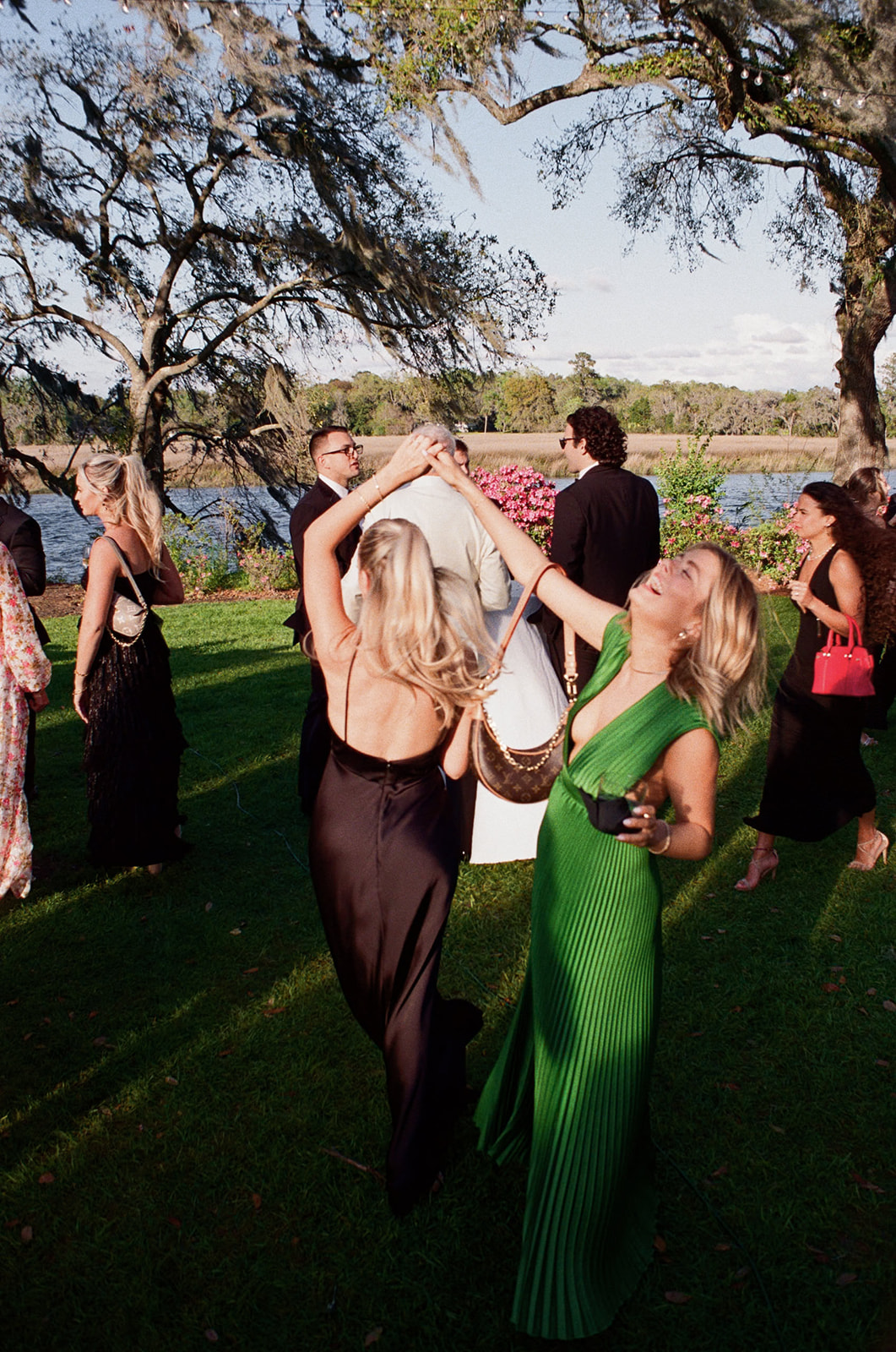 Wedding guests dancing during cocktail hour. Moment captured on film